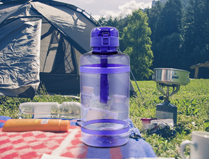 Why is it recommended to carry a large-capacity water bottle for outdoor camping